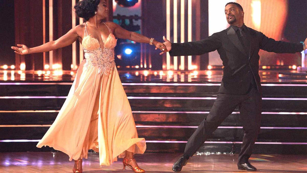 Tatyana Ali and Alfonso Ribeiro dance hand in hand on the Dancing with the Stars ballroom floor